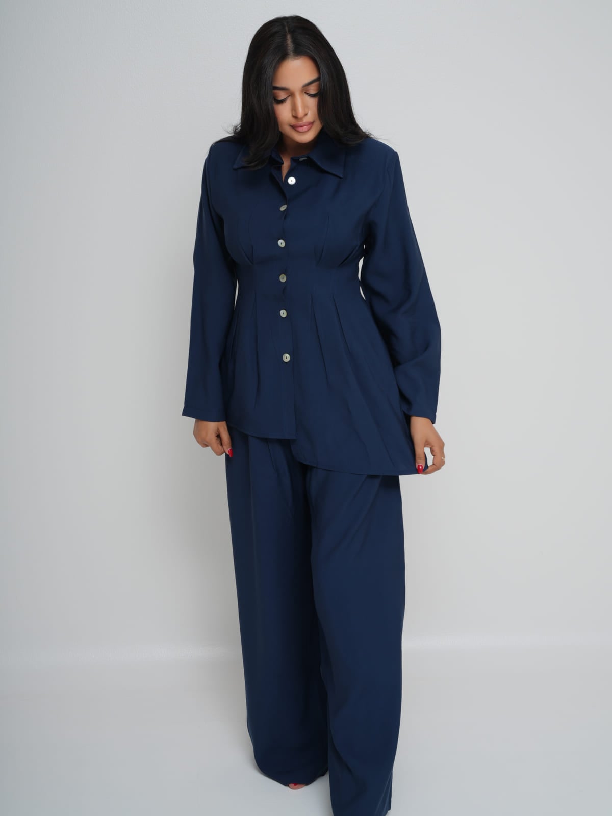 Navy Tencel shirt with an asymmetric hem, worn with matching wide-leg trousers
