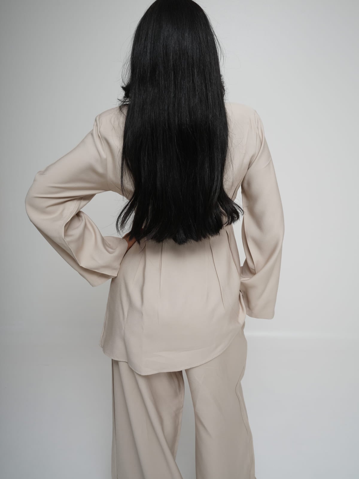 Cream Tencel shirt with structured shoulders and mother-of-pearl buttons, with matching wide-leg trousers