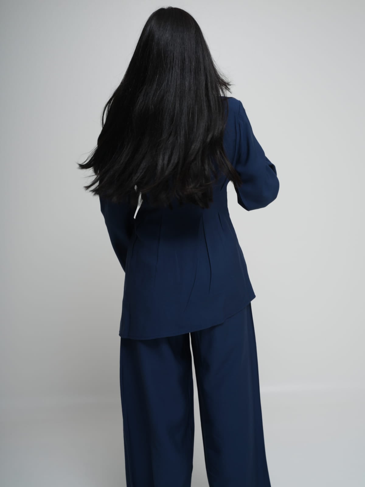 Navy Tencel shirt with an asymmetric hem, worn with matching wide-leg trousers
